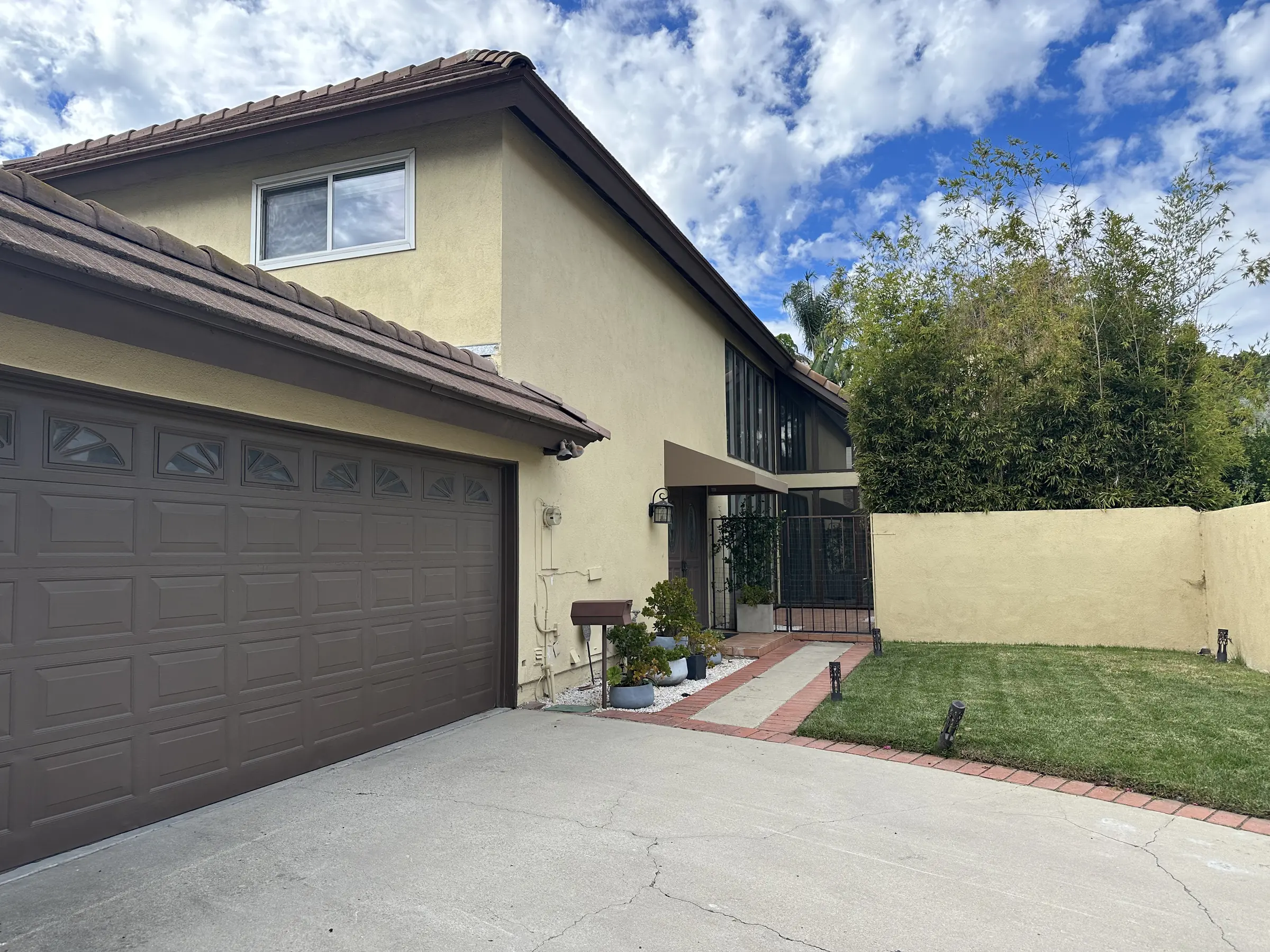 Front exterior of 1165 S Triunfo Canyon Road, framed by mature trees